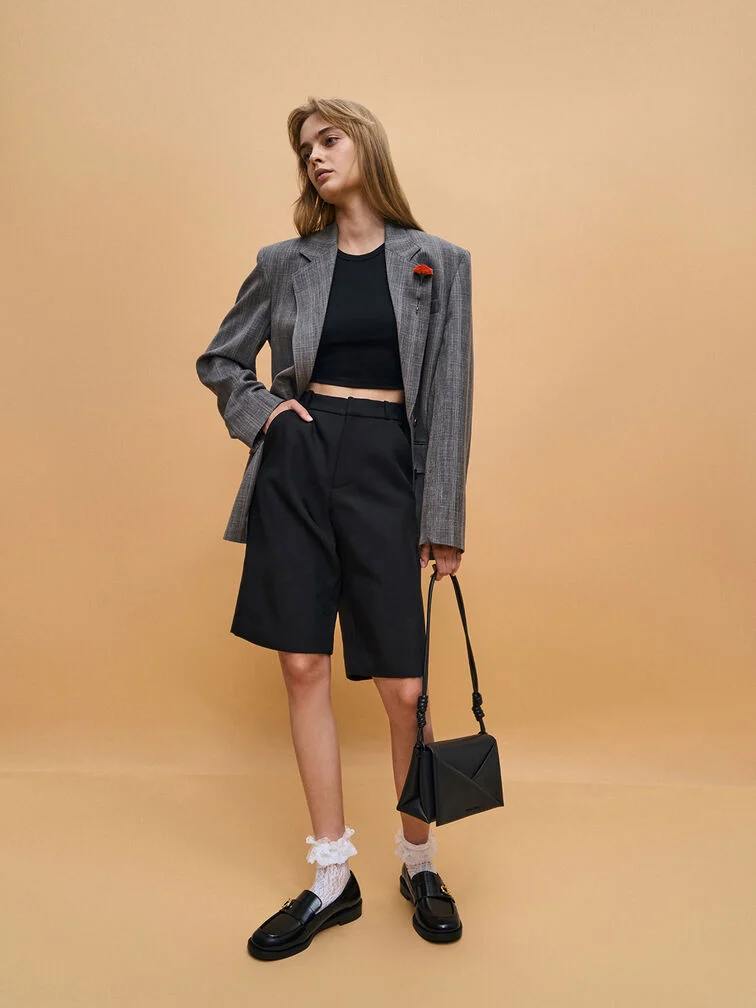 Black metallic-accent loafers styled with frilly ruffle socks.