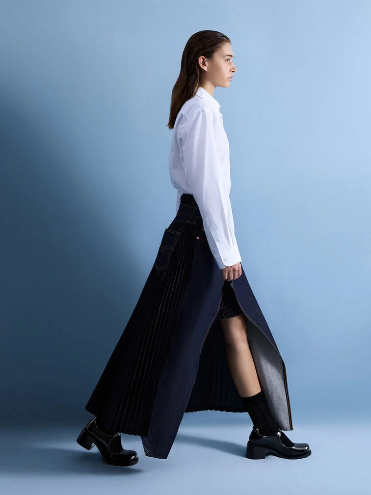 Black heeled Mary Janes paired with regular black cotton socks for a leg-lengthening look. 