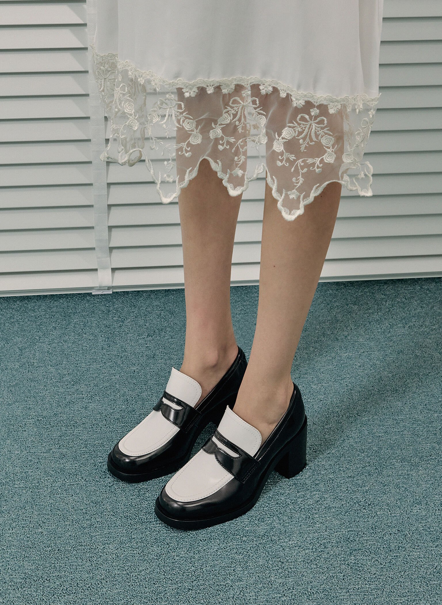 Black and white block heeled penny loafers best complemented by no-show socks.