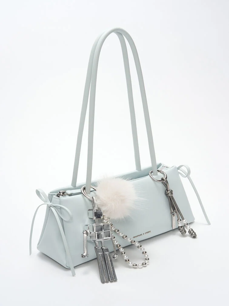 Sea-salt blue East-West bag embellished with metallic bag charms.