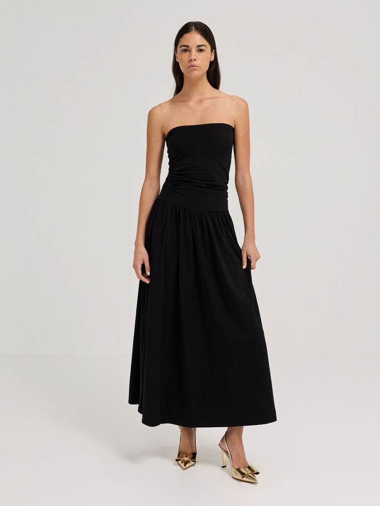 A black fitted A-line dress with gold heels is a classic combination.  