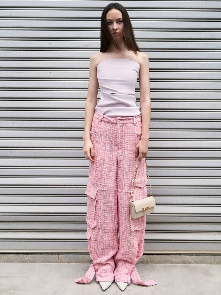 Quilted crossbody clutch with a strapless top and pink cargo pants, styled for a casual, everyday look. 