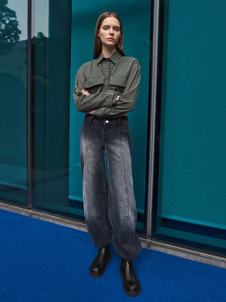 Chunky black ankle boots paired with washed denim jeans.