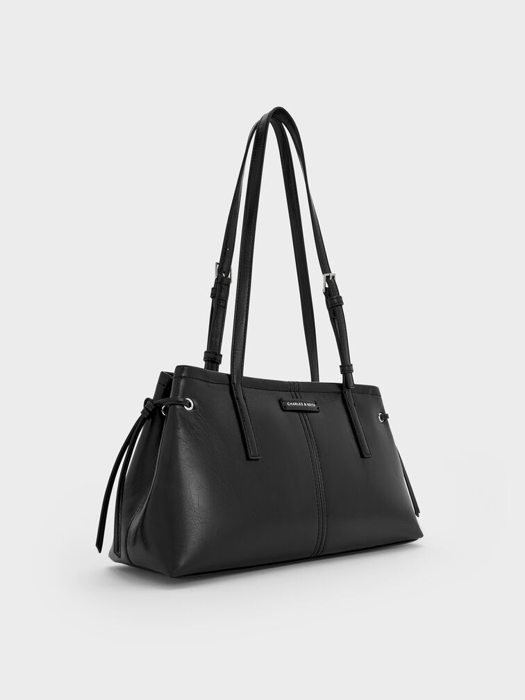 East-West bag in a versatile neutral tone, perfect for everyday wear.