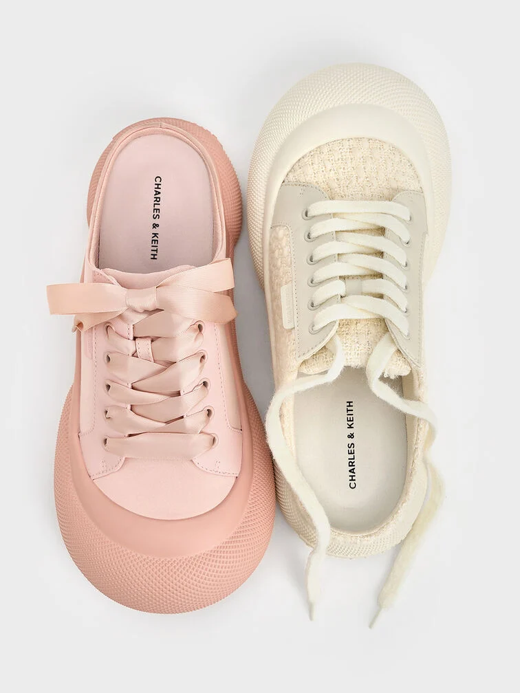 Sneaker mules blend the classic lace-up sneaker front with a mule’s open back for a casual, slip-on design.