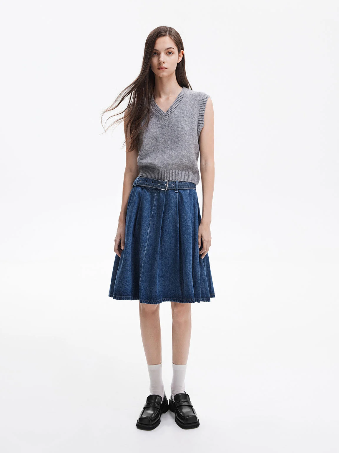 Black square-toe penny loafers paired with white crew socks.